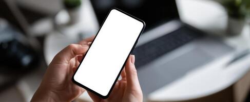 The smartphone held in hands with a blank screen for mockup and design purposes. photo