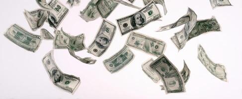 The whirlwind of dollar bills floating in the air against a white background. photo