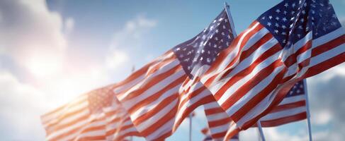 The vibrant American flags waving in the sunlight against the blue sky. photo