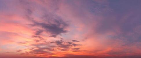 The stunning sunset illuminating the sky with vibrant colors and dramatic clouds. photo