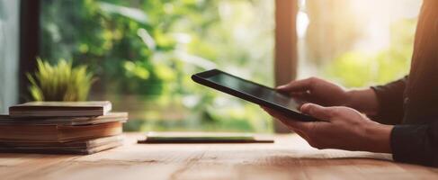 The tablet being used in a bright and inviting workspace surrounded by nature. photo