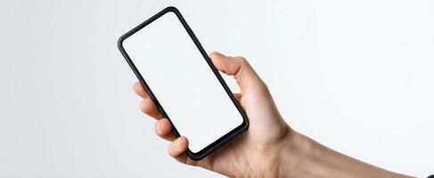 The smartphone held in hand with a blank screen ready for use. photo