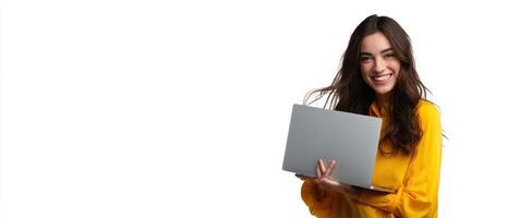 The cheerful woman holding a laptop in a bright yellow outfit. photo
