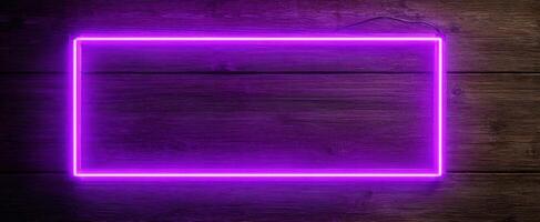 The Neon Purple Sign Glowing on a Wooden Background for Creative Designs photo