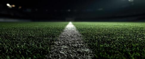 The vibrant green soccer field illuminated at night ready for competition. photo