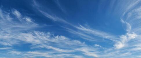 The Serene Beauty of Wispy Clouds Against a Deep Blue Sky photo