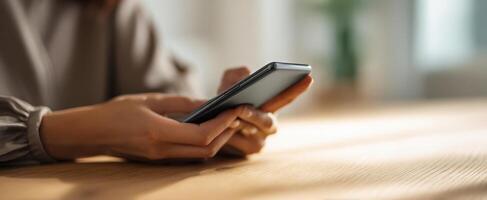 The smartphone in hands during a casual indoor environment. photo