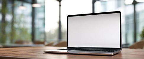 The sleek laptop on a wooden table in a modern office environment photo