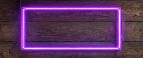 The Bright Purple Neon Frame Against a Rustic Wooden Background. photo