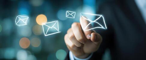 The innovative hand interacting with digital email notifications in a modern office. photo