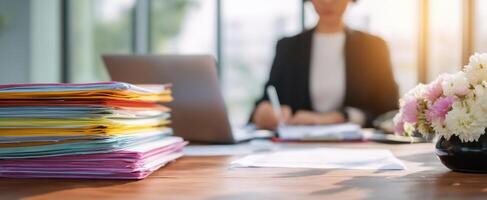 The Organized Workspace with Documents and a Professional Woman Writing. photo