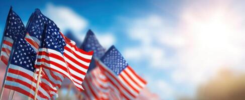 The American flags waving in the breeze against a bright sky. photo