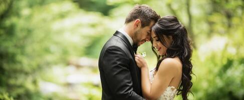 The romantic couple embracing in lush green forest setting. photo