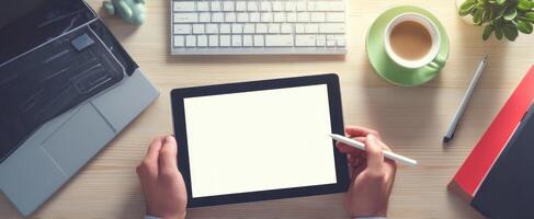 The tablet and coffee setup for a modern creative workspace. photo