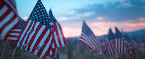 The American flags waving proudly in a serene sunset landscape. photo