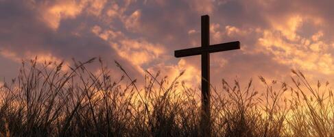 The serene silhouette of a cross against a stunning sunset backdrop. photo