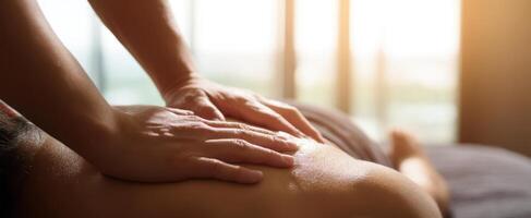 The soothing hands of a massage therapist relaxing a client's back. photo