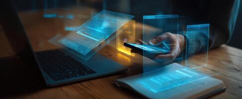 The modern workspace featuring a smartphone and laptop with digital holograms. photo