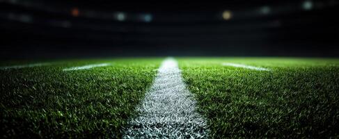 The football field illuminated under stadium lights at night. photo