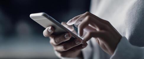 The close-up of hands interacting with a smartphone in a modern setting. photo