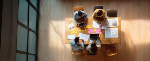 The productive teamwork session at a modern office table with diverse professionals. photo