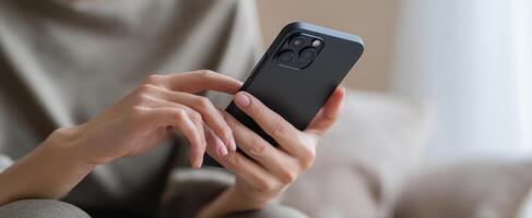 The smartphone in a person's hands during a casual, relaxed moment at home. photo