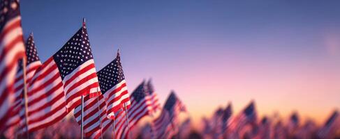 The American flags waving in the sunset sky create a patriotic atmosphere. photo