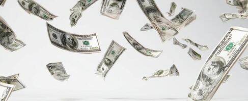 The abundance of flying dollar bills against a minimalist background. photo