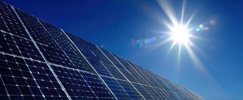 The solar panels capturing sunlight in a vibrant blue sky. photo