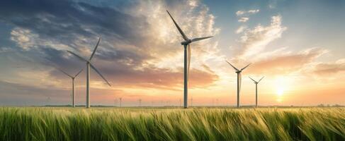 The Wind Turbines Standing Tall Against a Vibrant Sunset Over Fields. photo