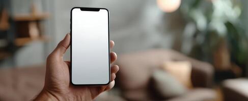 The smartphone held in hand showcasing a blank screen at home environment. photo