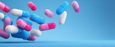 The colorful capsules floating against a blue background for health and wellness. photo