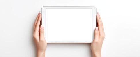 The tablet being held in hands with a blank screen for design projects. photo