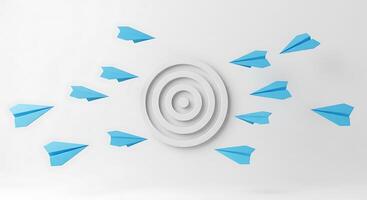 A white wall with blue paper airplanes flying around it photo