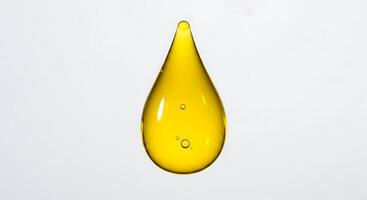 A drop of oil is shown on a white background photo