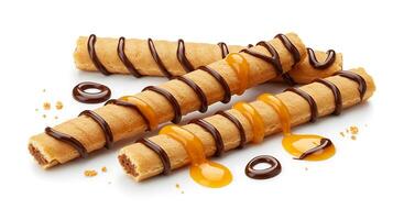 Three chocolate covered waffle sticks with caramel drizzle photo