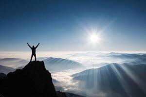 Silhouette Man Standing on Mountain Top Achieving Success Over Clouds During Sunrise photo