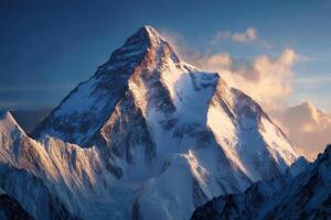Magnificent Mountain Peak Covered In Snow Under The Evening Sky With Soft Clouds photo