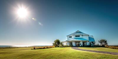 Modern house on a green field with a clear blue sky day photo