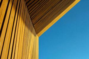 Wooden Structure Corner Against a Clear Blue Sky photo