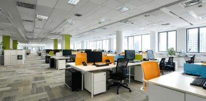 Bright contemporary office space with desks chairs and computers photo