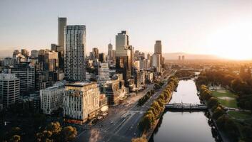 Cityscape Featuring Modern Architecture Along River During Golden Hour Sunlight photo