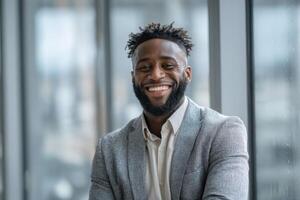 Confident Young Entrepreneur Smiling in Front of Office Building Windows With Warm Smile photo