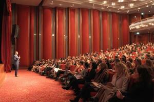 Public Speaking Event Inspiring Audience in Beautiful Theatre Interior Setting with Speaker photo