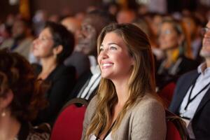 Enthusiastic Audience Members Listening to a Speaker at a Conference Session photo