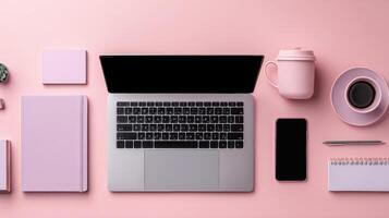 Minimalist Workspace Pink Desktop Flat Lay View of Laptop and Accessories photo