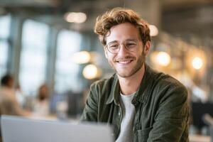 Smiling man in a modern workspace enjoying a good day at work photo