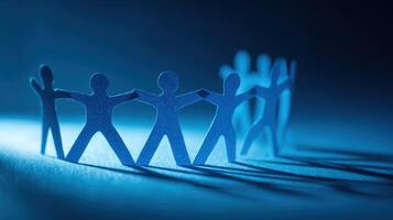 Paper Cutout Figures Holding Hands in a Circle Symbolizing Teamwork Success photo