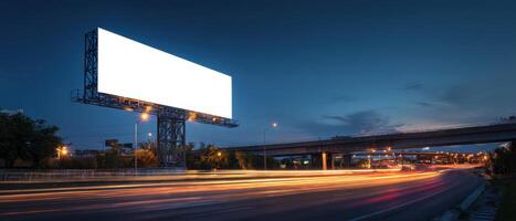Blank Billboard Lights Up the Night Sky Along the Busy Highway photo