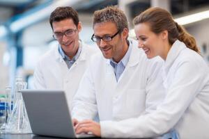 Scientists Collaborating on Laptop Exploring New Discoveries and Discussing Experimental Results photo